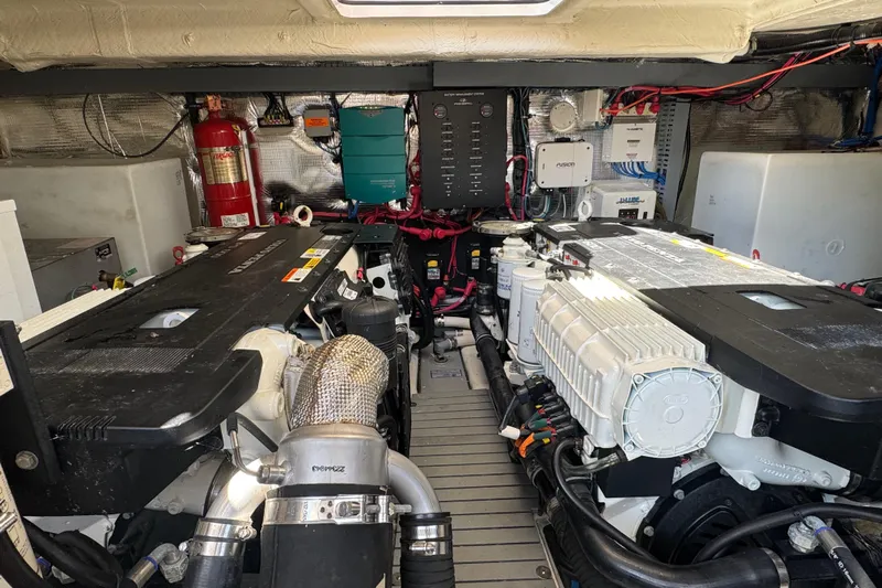 Tomtanic Yacht Photos Pics Engine room of a 2019 Regal 42 Fly yacht, showcasing dual engines and equipment.
