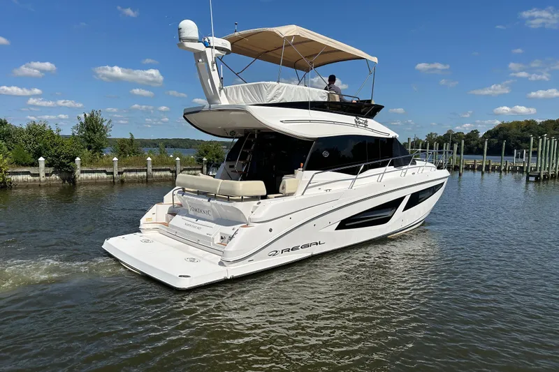 Tomtanic Yacht Photos Pics 2019 Regal 42 Fly yacht cruising on a sunny day, featuring sleek design and spacious deck.