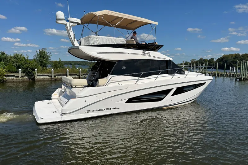 Tomtanic Yacht Photos Pics 2019 Regal 42 Fly yacht cruising on a sunny day, featuring sleek design and spacious deck.