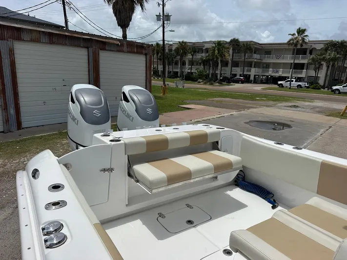  Yacht Photos Pics 2023 Cape Horn 32xs boat with Suzuki engines, beige seating, and coastal background.