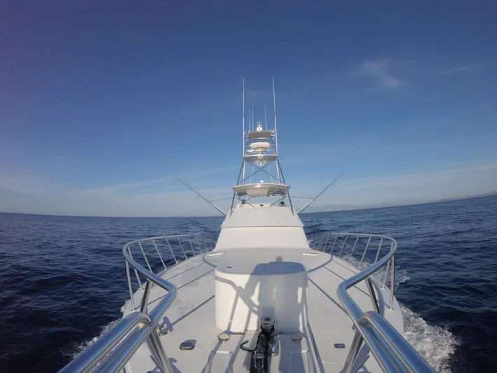  Yacht Photos Pics Bow view of 2001 Hatteras 60 Convertible yacht cruising on open sea.