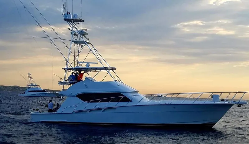  Yacht Photos Pics 2001 Hatteras 60 Convertible yacht on calm sea at sunset.
