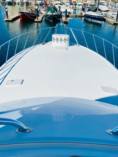  Yacht Photos Pics Bow view of 2001 Hatteras 60 Convertible yacht docked at marina.