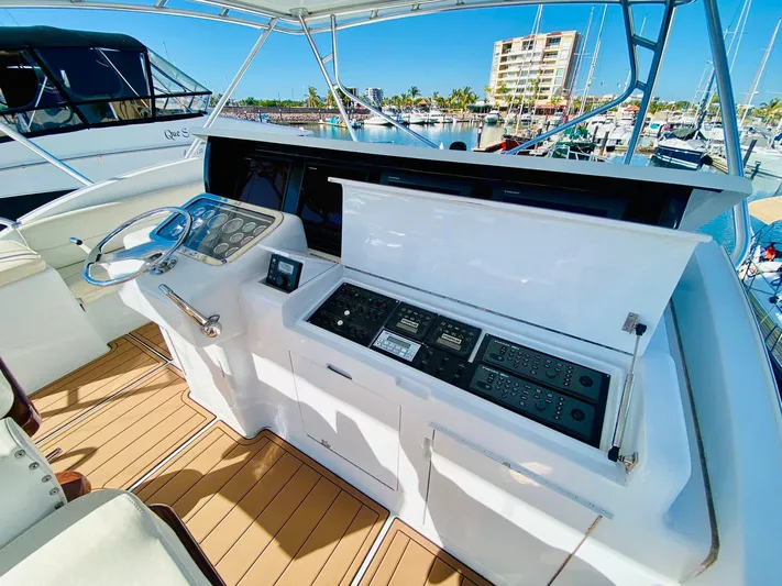  Yacht Photos Pics Helm of 2001 Hatteras 60 Convertible yacht with modern controls and wooden deck.