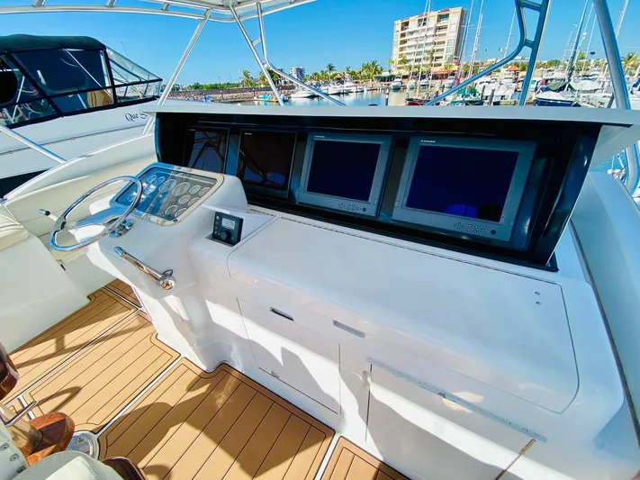  Yacht Photos Pics Helm of 2001 Hatteras 60 Convertible yacht with dual screens and controls.