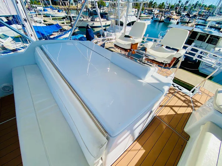  Yacht Photos Pics 2001 Hatteras 60 Convertible yacht deck with seating, docked at marina.