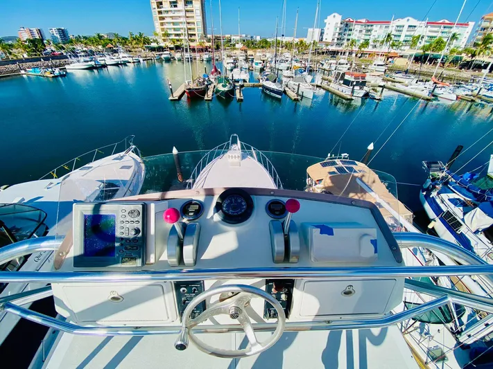  Yacht Photos Pics Helm view of 2001 Hatteras 60 Convertible yacht in a marina.