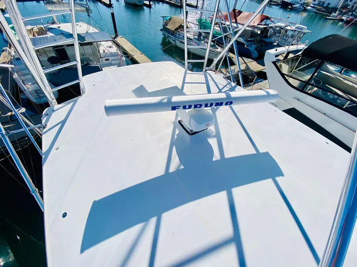  Yacht Photos Pics Hatteras 60 Convertible 2001 yacht deck with Furuno radar, docked at marina.