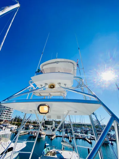  Yacht Photos Pics 2001 Hatteras 60 Convertible yacht in sunny marina, blue sky background.