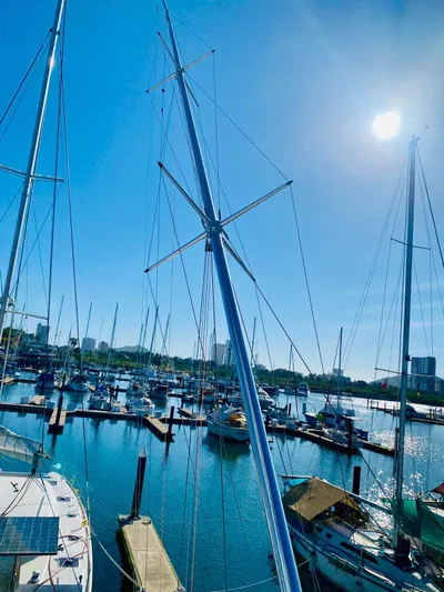  Yacht Photos Pics Marina with sailboats under clear blue sky, featuring a 2001 Hatteras 60 Convertible.