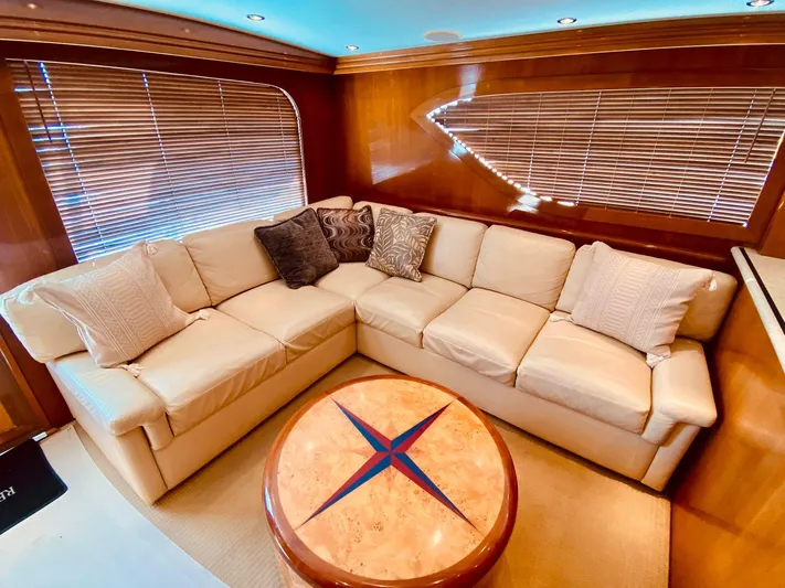  Yacht Photos Pics Luxurious interior of 2001 Hatteras 60 Convertible yacht with plush seating and elegant decor.