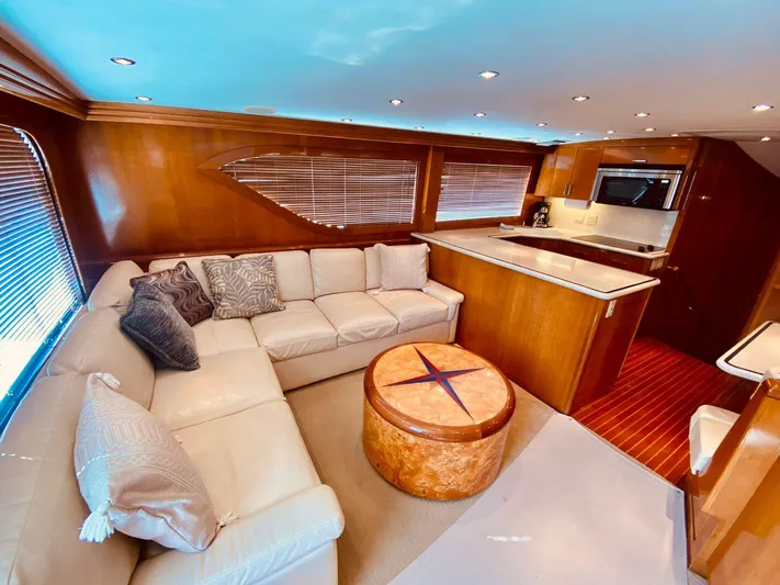  Yacht Photos Pics Luxurious interior of 2001 Hatteras 60 Convertible yacht with plush seating and modern kitchen.