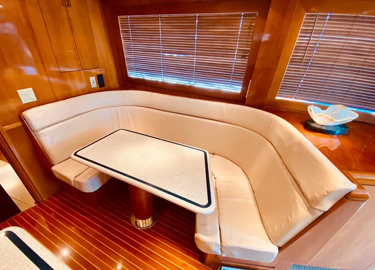  Yacht Photos Pics Luxurious interior of 2001 Hatteras 60 Convertible yacht with elegant seating and table.