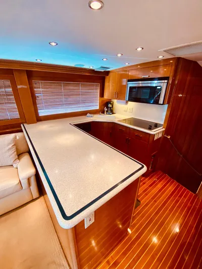  Yacht Photos Pics Luxurious interior of 2001 Hatteras 60 Convertible yacht with modern kitchen design.