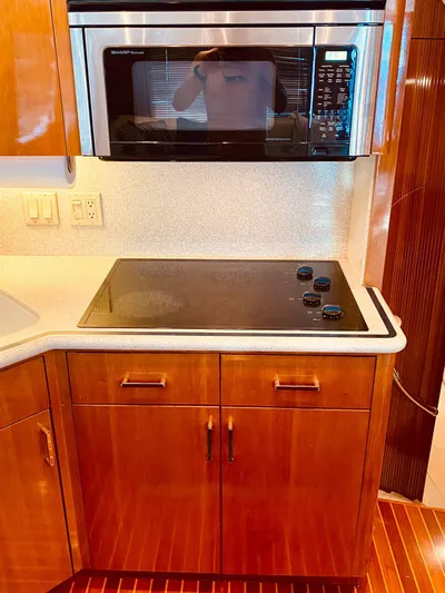  Yacht Photos Pics 2001 Hatteras 60 Convertible kitchen with stovetop and microwave.