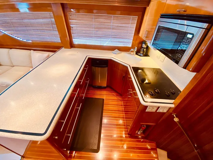  Yacht Photos Pics Luxurious kitchen interior of 2001 Hatteras 60 Convertible yacht with modern appliances.