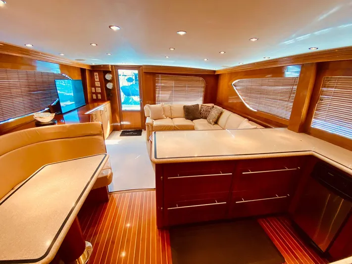  Yacht Photos Pics Luxurious interior of 2001 Hatteras 60 Convertible yacht with elegant wood finishes.