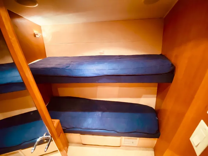  Yacht Photos Pics Bunk beds in 2001 Hatteras 60 Convertible yacht cabin with blue bedding.
