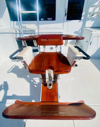  Yacht Photos Pics Captain's chair on 2001 Hatteras 60 Convertible yacht, featuring "Reel Energy" branding.