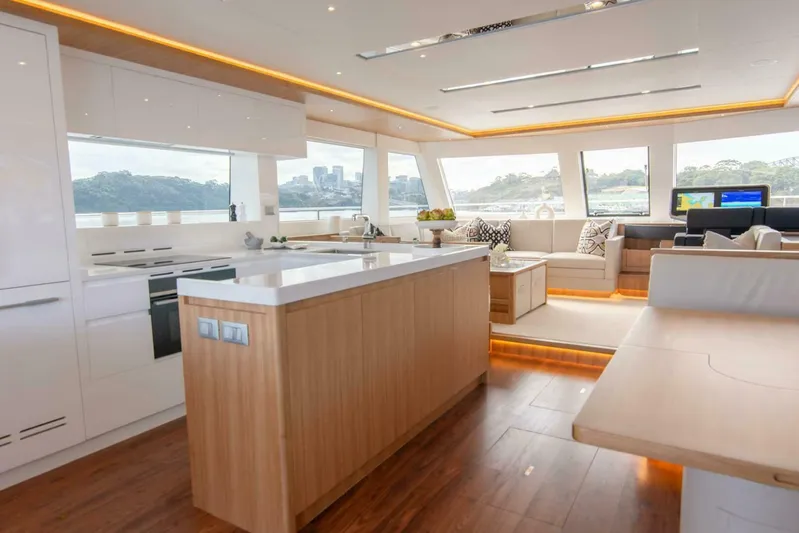 53e Iliad 2026 Yacht Photos Pics Luxurious interior of 2026 ILIAD 53E yacht with modern kitchen and seating area.