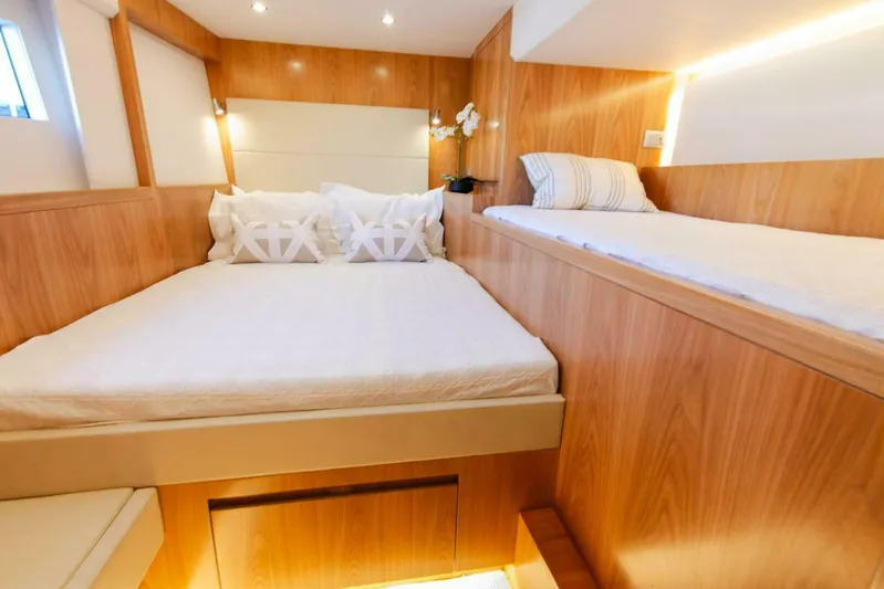 53e Iliad 2026 Yacht Photos Pics Luxurious ILIAD 53E 2026 yacht cabin with wooden interior and cozy bedding.