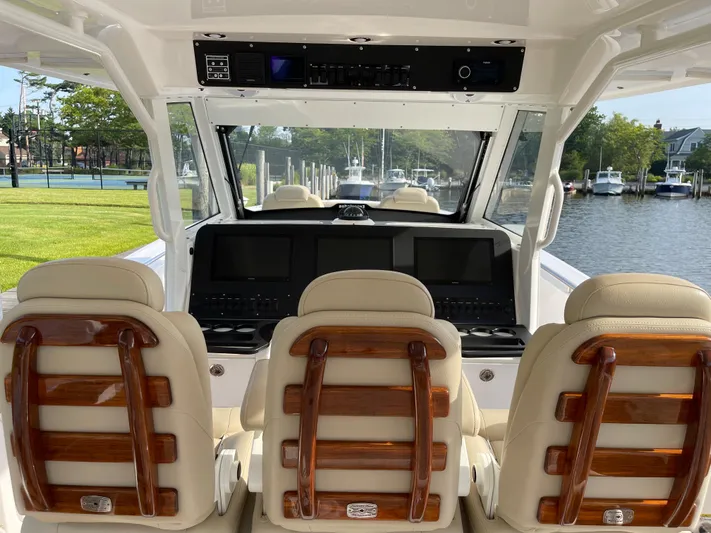  Yacht Photos Pics Interior view of 2019 Everglades 435 CC boat with luxurious seating and control panel.