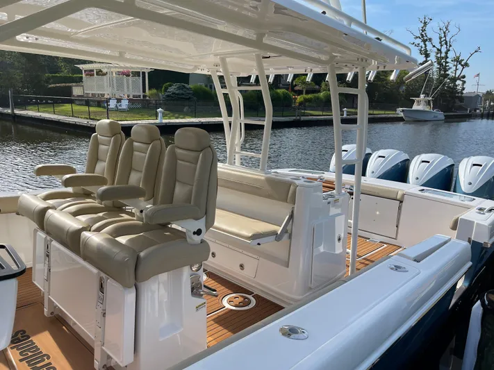  Yacht Photos Pics 2019 Everglades 435 CC boat with luxurious seating and multiple engines docked by the water.