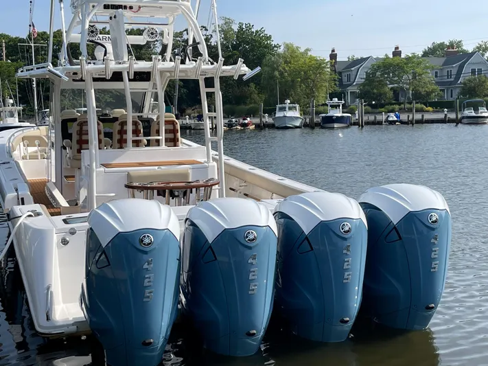  Yacht Photos Pics 2019 Everglades 435 CC boat with four Yamaha outboard engines docked by waterfront homes.