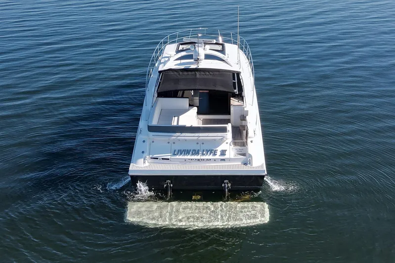 Livin Da Lyfe Yacht Photos Pics 2013 Sea Ray 510 Sundancer yacht cruising on calm waters, rear view.