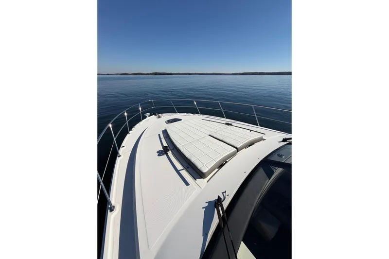 Livin Da Lyfe Yacht Photos Pics 2013 Sea Ray 510 Sundancer yacht on calm water, featuring spacious deck and sunbathing area.