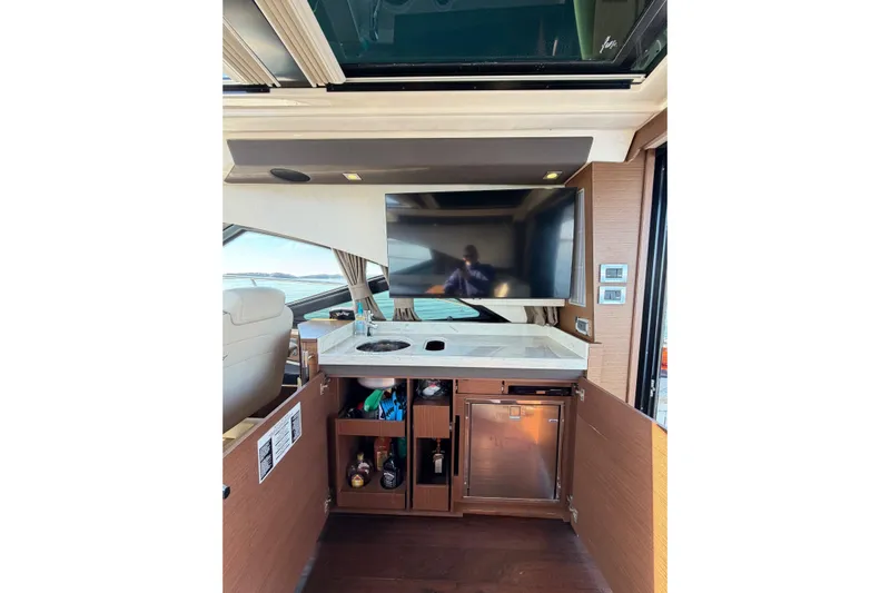 Livin Da Lyfe Yacht Photos Pics Luxurious interior of 2013 Sea Ray 510 Sundancer yacht with TV and mini bar.