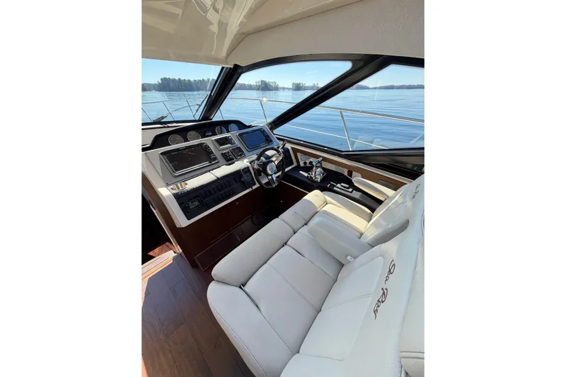 Livin Da Lyfe Yacht Photos Pics Luxurious interior of 2013 Sea Ray 510 Sundancer yacht with modern helm and plush seating.