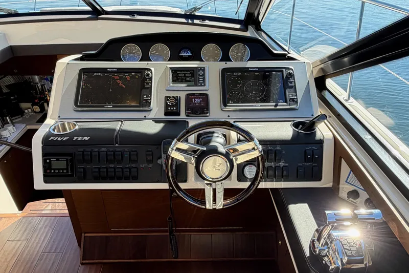 Livin Da Lyfe Yacht Photos Pics 2013 Sea Ray 510 Sundancer helm with navigation screens and steering wheel.