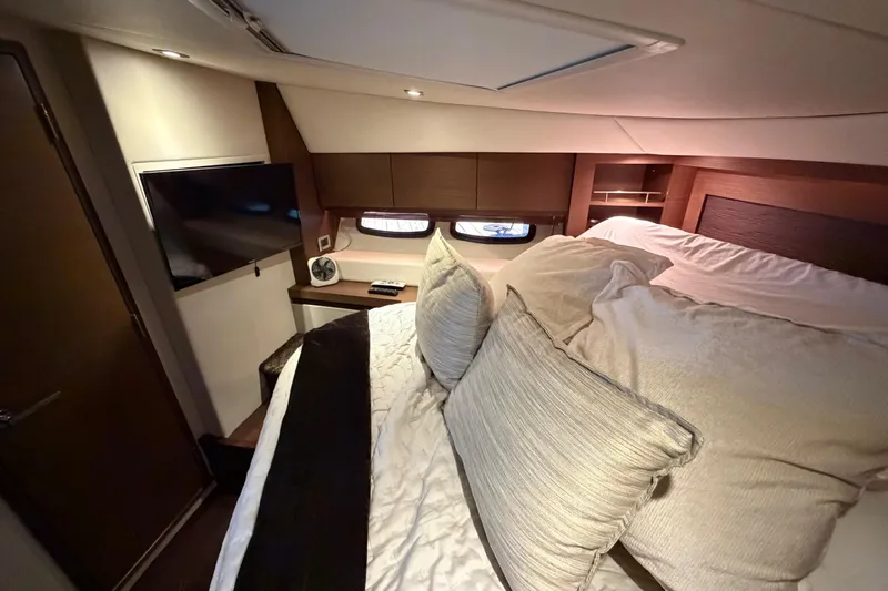 Livin Da Lyfe Yacht Photos Pics Luxurious cabin interior of 2013 Sea Ray 510 Sundancer yacht with cozy bedding and TV.