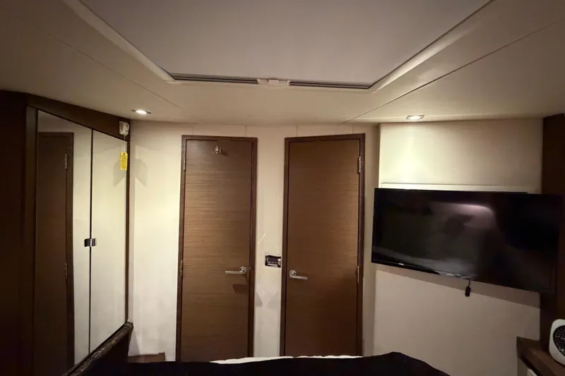 Livin Da Lyfe Yacht Photos Pics Interior of 2013 Sea Ray 510 Sundancer yacht with TV, mirrored closet, and wooden doors.