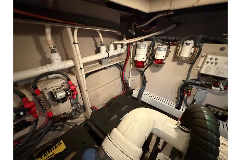 Livin Da Lyfe Yacht Photos Pics Engine room of 2013 Sea Ray 510 Sundancer with visible pipes and electrical components.