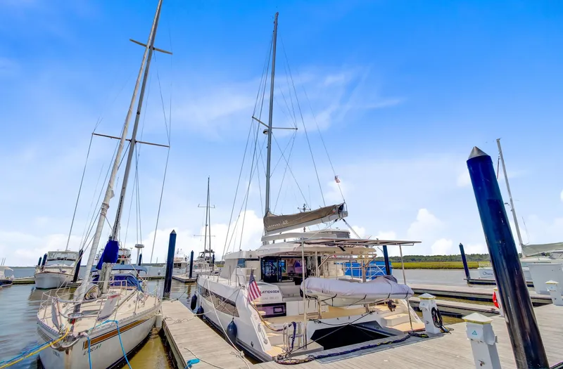 Latidoods Yacht Photos Pics 2021 Leopard 42 catamaran docked at marina under clear blue sky.