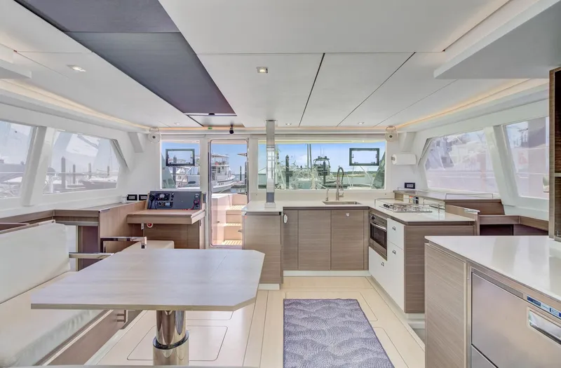 Latidoods Yacht Photos Pics Luxurious interior of a 2021 Leopard 42 catamaran with modern kitchen and dining area.