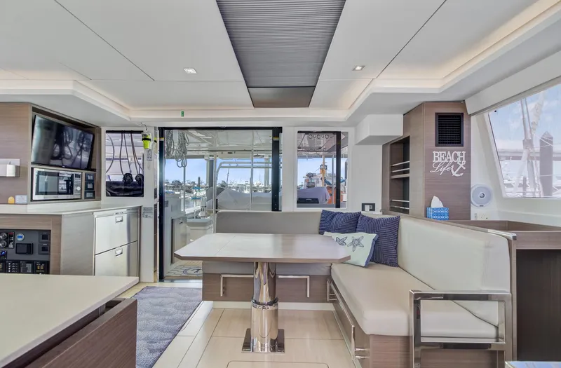Latidoods Yacht Photos Pics Luxurious interior of 2021 Leopard 42 catamaran with modern seating and dining area.