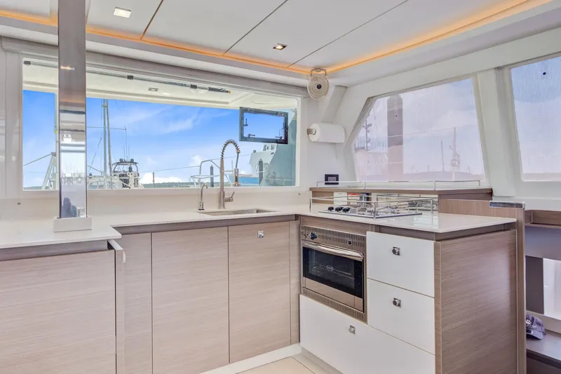 Latidoods Yacht Photos Pics Modern kitchen interior on a 2021 Leopard 42 yacht, featuring sleek cabinetry and appliances.