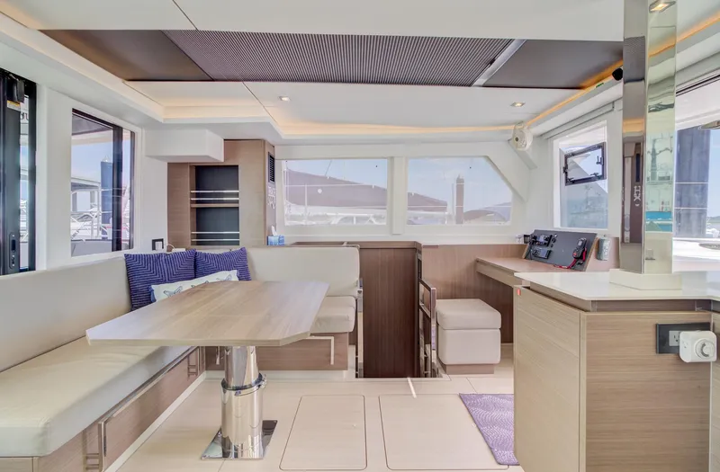 Latidoods Yacht Photos Pics Modern interior of 2021 Leopard 42 yacht with dining area and navigation station.