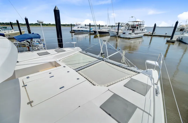 Latidoods Yacht Photos Pics Modern Leopard 42 catamaran docked at marina, showcasing spacious deck and netting, 2021 model.