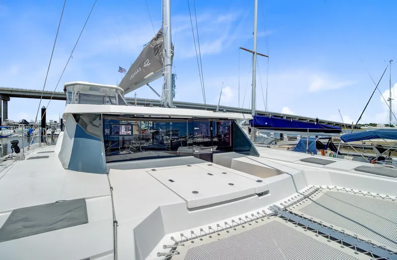Latidoods Yacht Photos Pics 2021 Leopard 42 catamaran docked at marina, showcasing sleek design and spacious deck.