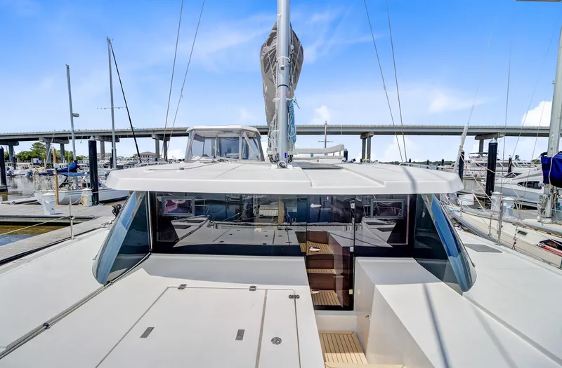 Latidoods Yacht Photos Pics Modern Leopard 42 catamaran deck, 2021 model, docked at marina under clear blue sky.