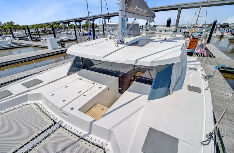 Latidoods Yacht Photos Pics 2021 Leopard 42 catamaran docked at marina, showcasing spacious deck and modern design.