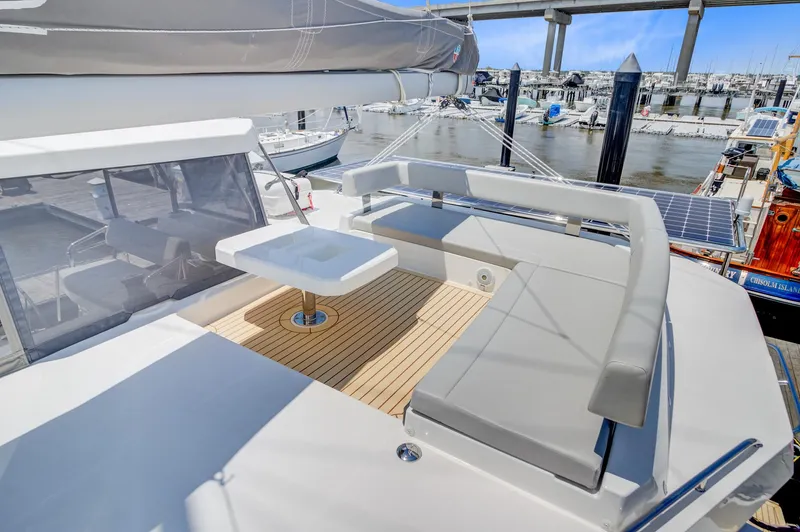 Latidoods Yacht Photos Pics 2021 Leopard 42 yacht with spacious deck, modern seating, and marina view.