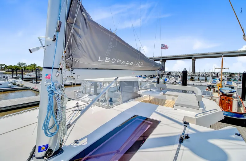 Latidoods Yacht Photos Pics 2021 Leopard 42 catamaran docked at marina, featuring sleek design and modern sail.