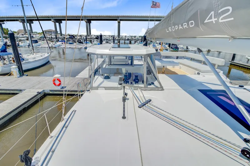 Latidoods Yacht Photos Pics Catamaran Leopard 42 docked at marina, showcasing sleek design and spacious deck, 2021 model.