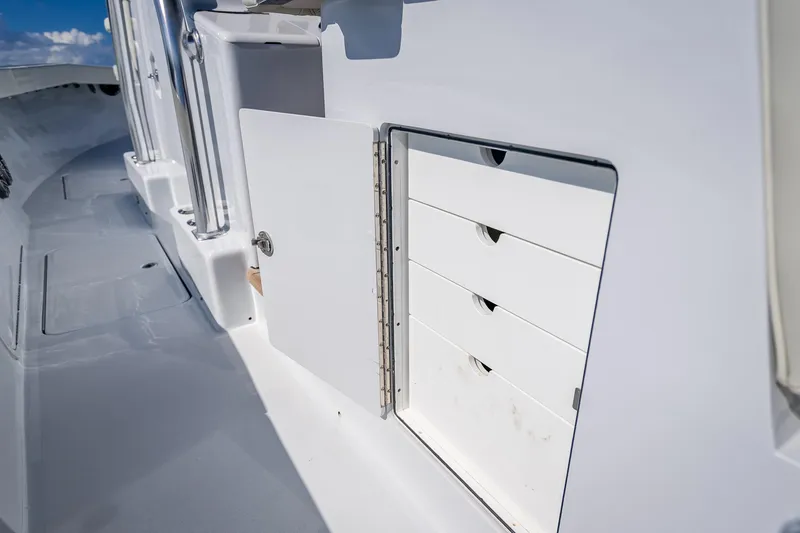  Yacht Photos Pics Open storage compartment on 2027 Billfish 39 boat deck, showcasing organized drawers.