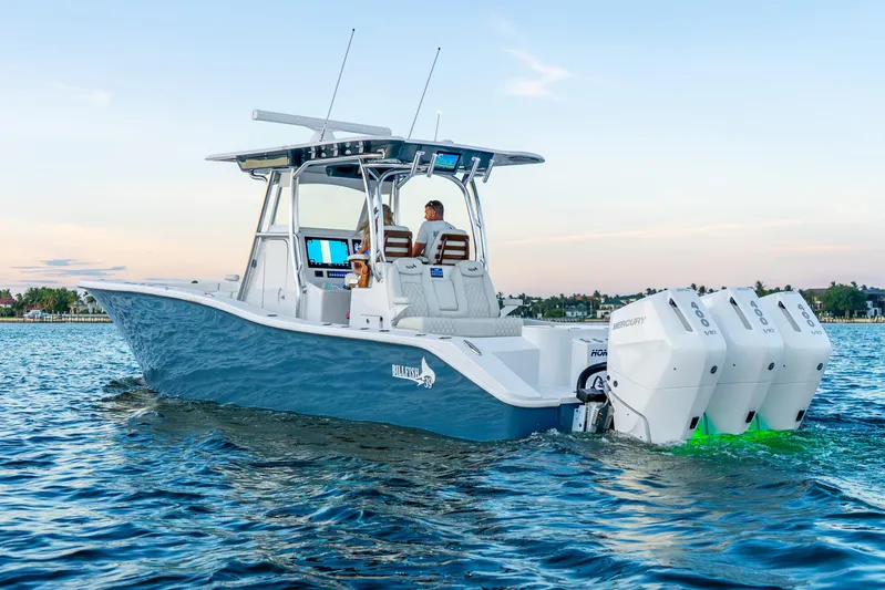  Yacht Photos Pics 2027 Billfish 39 boat with triple Mercury engines cruising on calm water.